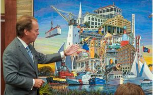 Gulfport Mayor Billy Hewes unveils a commissioned painting by Charles Buckley in honor of the Gulfport 125th Anniversary - July 2023 (Photo from City of Gulfport Mayor's office on Facebook)