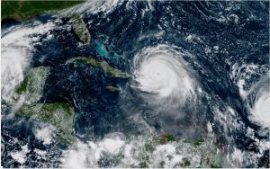 In this geocolor image GOES-16 satellite image taken Thursday, Sep. 7, 2017, at 11:15 a.m. EDT, shows the eye of Hurricane Irma, center, just north of the island of Hispaniola, with Hurricane Katia, left, in the Gulf of Mexico, and Hurricane Jose, right, in the Atlantic Ocean. Irma, a fearsome Category 5 storm, cut a path of devastation across the northern Caribbean, leaving at least 10 dead and thousands homeless after destroying buildings and uprooting trees on a track Thursday that could lead to a catastrophic strike on Florida. (NOAA via AP)