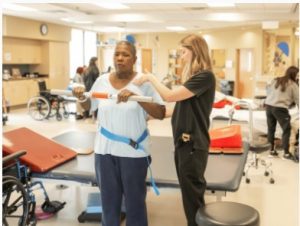 Hurrod works with Lindsey Klaus, occupational therapist at Methodist Rehabilitation Center, during physical therapy.