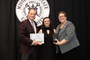 Olivia Springfield, center, receives the Spirit of State Award from MSU President Mark E. Keenum and Vice President for Student Affairs Regina Hyatt. (Photo by Jonah Holland)