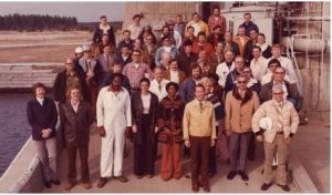 An image from 1975 shows the original space shuttle main engine test team standing at the base of the A-1 Test Stand, now known as the Fred Haise Test Stand. Lee English Sr., front right, is pictured holding a white hard hat. (Photo courtesy of NASA).
