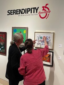 Wyatt Waters, renowned watercolor artist, and Ceci Whitehurst, MSH Art Services Supervisor, discuss the elements of the artwork on display as part of the Serendipity Sneak Peek exhibit.