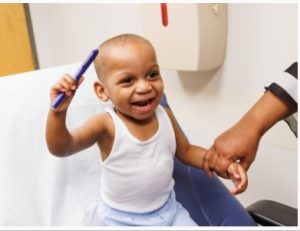 Kobe smiles while holding a pen shortly after his cast was removed.