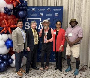 Janita Stewart with the 2024 Small Business Person of the Year, John Ruskey of Quapaw Canoe Company of Clarksdale