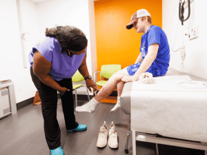 Hodge, director of the Mississippi Burn Center at UMMC, examines Josey in a follow-up appointment.