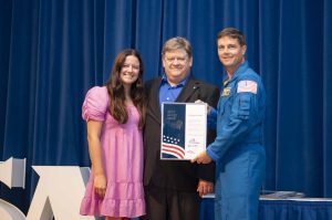 NASA’s Stennis Space Center employee Michael Brown, a native of Cerritos, California, and resident of Slidell, Louisiana, receives the prestigious Space Flight Awareness Silver Snoopy award from NASA astronaut Reid Wiseman during the Aug. 21 ceremony. He is accompanied by his daughter, Allison. Photo Credit: NASA/Danny Nowlin
