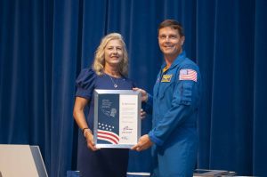 NASA’s Stennis Space Center employee Rhonda Lavigne, a native of Pass Christian, Mississippi, and resident of Gulfport, Mississippi, receives the prestigious Space Flight Awareness Silver Snoopy award from NASA astronaut Reid Wiseman during the Aug. 21 ceremony. Photo Credit: NASA/Danny Nowlin