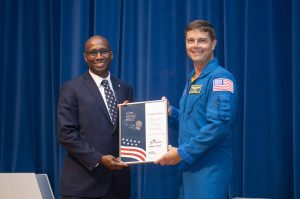 NASA’s Stennis Space Center employee Benjamin Stevens, a native of Lake Charles, Louisiana, and resident of Picayune, Mississippi, receives the prestigious Space Flight Awareness Silver Snoopy award from NASA astronaut Reid Wiseman during the Aug. 21 ceremony. Photo Credit: NASA/Danny Nowlin