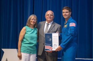 NASA’s Stennis Space Center employee Glenn Varner, a native and resident of Gulfport, Mississippi, receives the prestigious Space Flight Awareness Silver Snoopy award from NASA astronaut Reid Wiseman during the Aug. 21 ceremony. He is accompanied by his wife, Delana. Photo Credit: NASA/Danny Nowlin