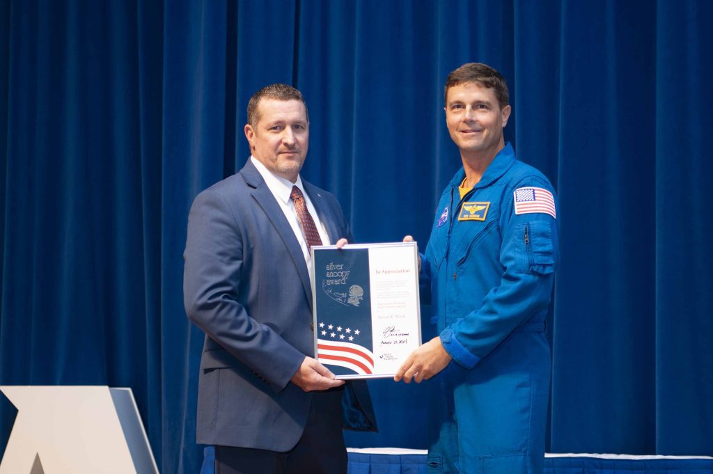 NASA’s Stennis Space Center employee Steven Wood, a native and resident of Picayune, Mississippi, receives the prestigious Space Flight Awareness Silver Snoopy award from NASA astronaut Reid Wiseman during the Aug. 21 ceremony. Photo Credit: NASA/Danny Nowlin