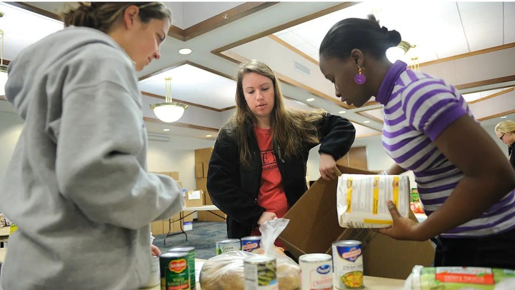 Ole Miss students help assemble baskets using donated food items to provide Thanksgiving meals for the Adopt-a-Basket program. Photo by Kevin Bain/Ole Miss Digital Imaging Services