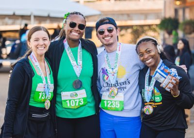 From left, registered nurses Alyssa Brady, India White and John Carpenter and Kaylyn Turner of Byram smile after finishing the Run the Rainbow 5K.