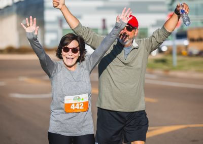 Dr. Mary Taylor, Suzan B. Thames Chair and professor of pediatrics, and her husband, Michael Taylor, wave during the half marathon.