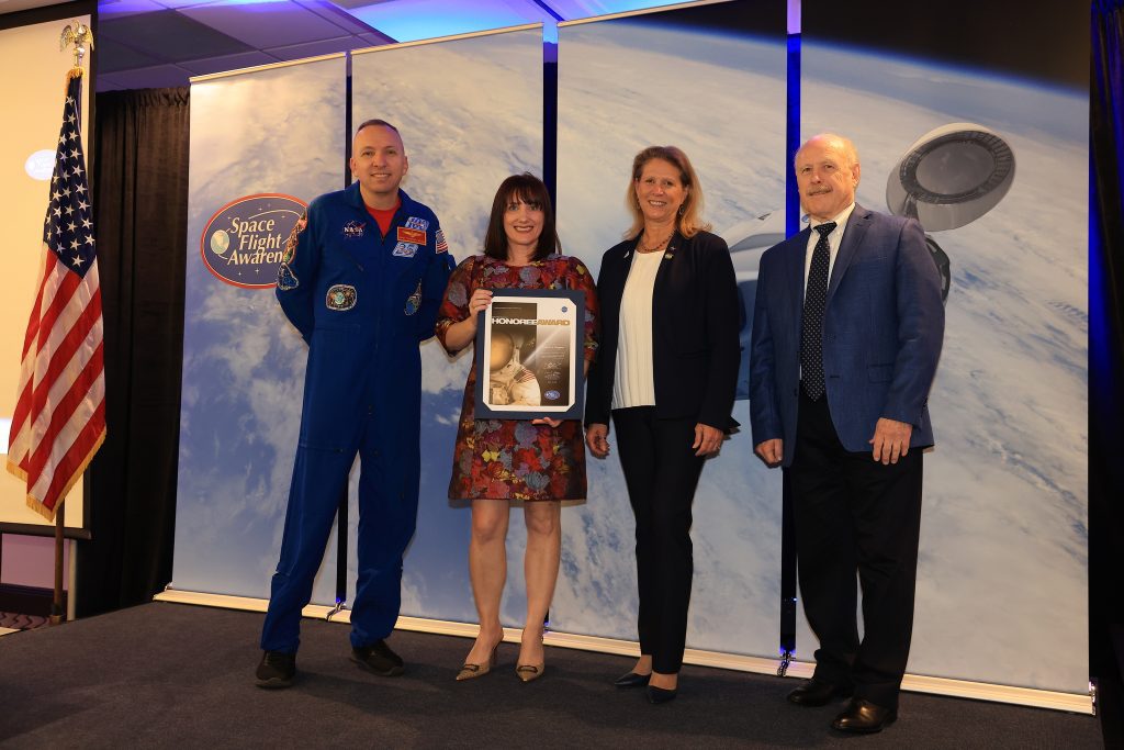 Stennis Space Center employee Melissa Wagner of Pass Christian, Mississippi, is presented with the NASA Space Flight Awareness Program Honoree Award during a March 10 ceremony. Wagner (second from left) receives the award from (left to right): NASA astronaut Randy Bresnik, NASA Exploration Systems Development Mission Directorate Acting Associate Administrator Dr. Lori Glaze, and NASA Space Operations Mission Directorate Associate Administrator Kenneth Bowersox. Photo Credit: (NASA/Kennedy Space Center)