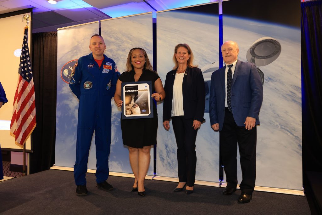 NASA’s Stennis Space Center employee Samone Wilson of Hattiesburg, Mississippi, is presented with the NASA Space Flight Awareness Program Honoree Award during a March 10 ceremony. Wilson (second from left) receives the award from (left to right): NASA astronaut Randy Bresnik, NASA Space Operations Mission Directorate Associate Administrator Kenneth Bowersox, and NASA Exploration Systems Development Mission Directorate Acting Associate Administrator Dr. Lori Glaze. Photo Credit: NASA/Kennedy Space Center