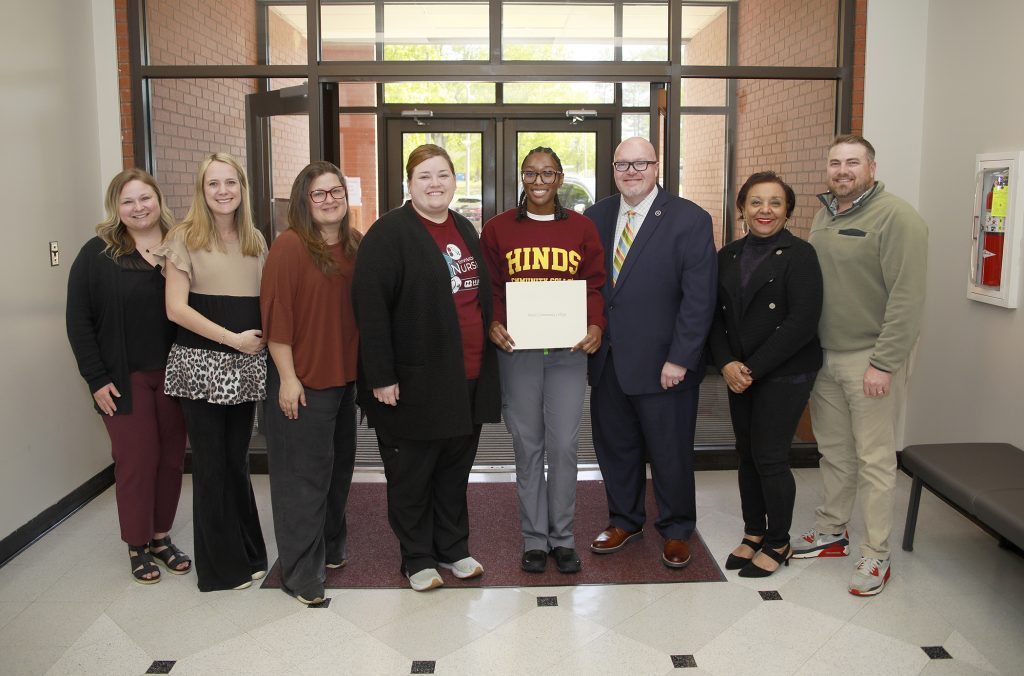 N’Kyah Kendrick of Jackson, center, was awarded the annual Carla McCulloch Scholarship given to a second semester Associate Degree Nursing Student at Hinds Community College each year. She is with Hinds nursing faculty including Director of Associate Degree Nursing Brittany Meacham, ADN Instructor Taylor Hawk, ADN Instructor Whitney Nesbit, ADN Instructor Carmen Rogers, Vice President and Executive Director of the Hinds Community College Foundation Matt Jones, ADN Instructor Irish Patrick-Williams and ADN Instructor Justin Whatley.