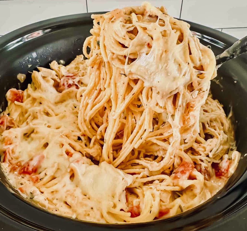 Why spend time standing over a hot stove making and then baking chicken spaghetti when you can let your trusty Crockpot do the hard work? Just fix it and forget it, then enjoy a delicious dish of cheesy, spicy Crockpot Chicken Spaghetti.  