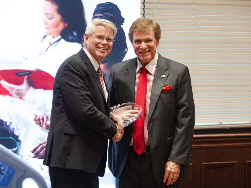 William Carey University President Ben Burnett, left, welcomes David Bush into the WCU Alumni Hall of Fame.