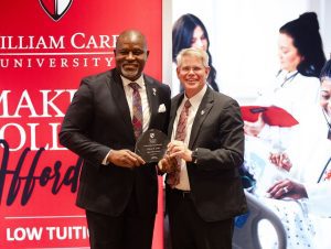 William Carey University President Ben Burnett, right, welcomes Tracy Cook into the WCU Alumni Hall of Fame.