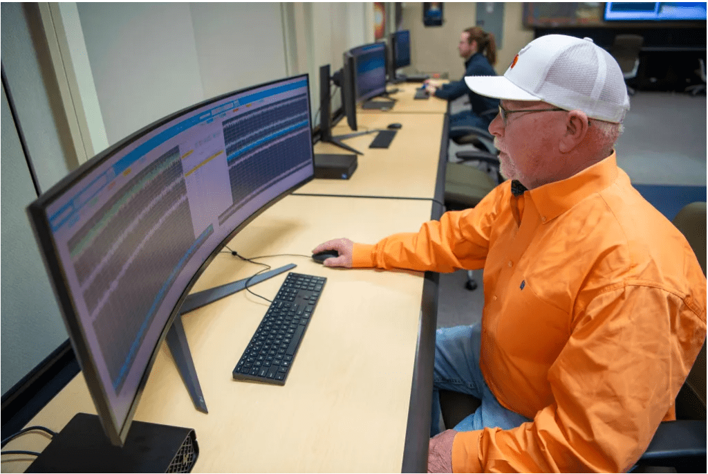 Syncom Space Services software engineer Richard Smith, front, analyzes test results using the NASA Data Acquisition System Displays interface at NASA’s Stennis Space Center while NASA software engineer Brandon Carver actively tests and develops laboratory equipment. (Photo Credit: NASA/Danny Nowlin)
