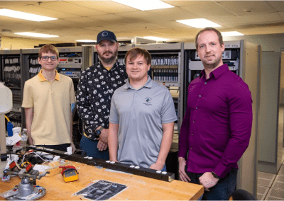 NASA engineers, from left to right, Tristan Mooney, Steven Helmstetter Chase Aubry, and Christoffer Barnett-Woods are shown in the E-1 Test Control Center where the NASA Data Acquisition System is utilized for propulsion test activities. (Photo Credit: NASA/Danny Nowlin)