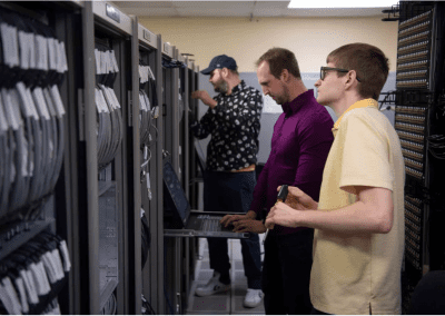 NASA engineers Steven Helmstetter, Christoffer Barnett-Woods, and Tristan Mooney perform checkouts on a large data acquisition system for the E-1 Test Stand at NASA’s Stennis Space Center. The data acquisition hardware, which supports testing for E Test Complex commercial customers, is controlled by NASA Data Acquisition System software that allows engineers to view real-time data while troubleshooting hardware configuration. (Photo Credit: NASA/Danny Nowlin)