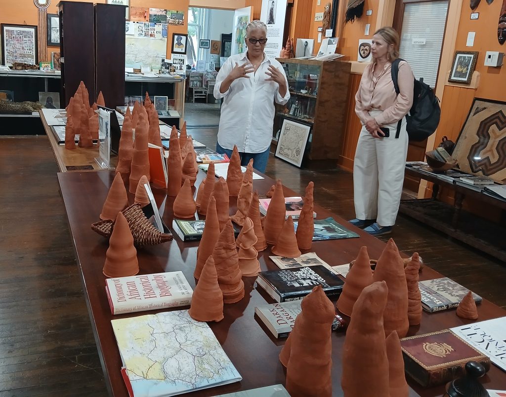 Woven Wind representatives Melisande Short-Colomb, left, and Vesna Pavlović, discuss the clay sculptures of the Cypress Knees exhibit held April 25 in Natchez.
