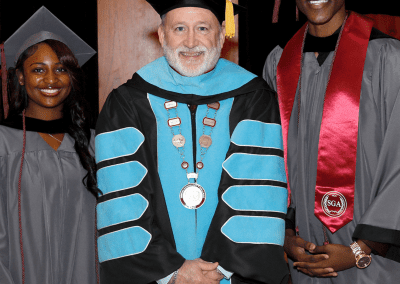 Destiny Young of Raymond, left, was the speaker for the 2 p.m. May 15 graduation ceremony at Hinds Community College. D'Jaydyn Readus of Bolton, right, offered the invocation and benediction. They are with Hinds President Dr. Stephen Vacik.