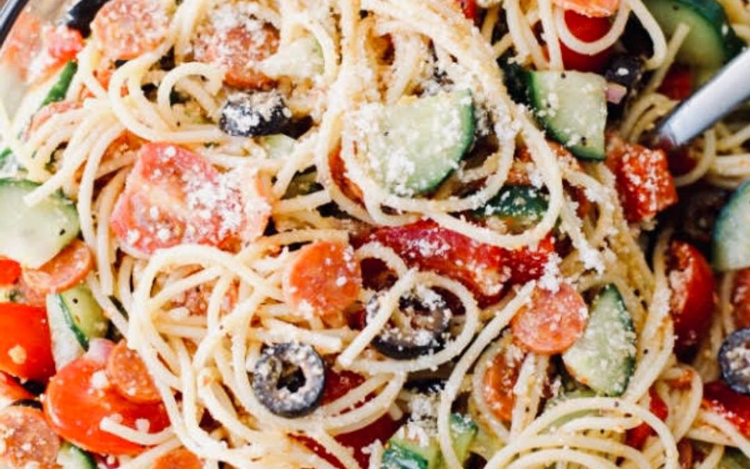 Spaghetti salad, full of chopped vegetables and tangy dressing, is the perfect hot-weather meal or side dish.
