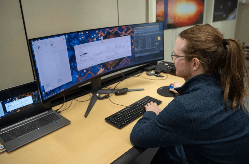 NASA software engineer Brandon Carver updates how the main data acquisition software processes information at NASA’s Stennis Space Center, where he has contributed to the creation of the center’s first-ever open-source software. (Photo Credit: NASA/Danny Nowlin)