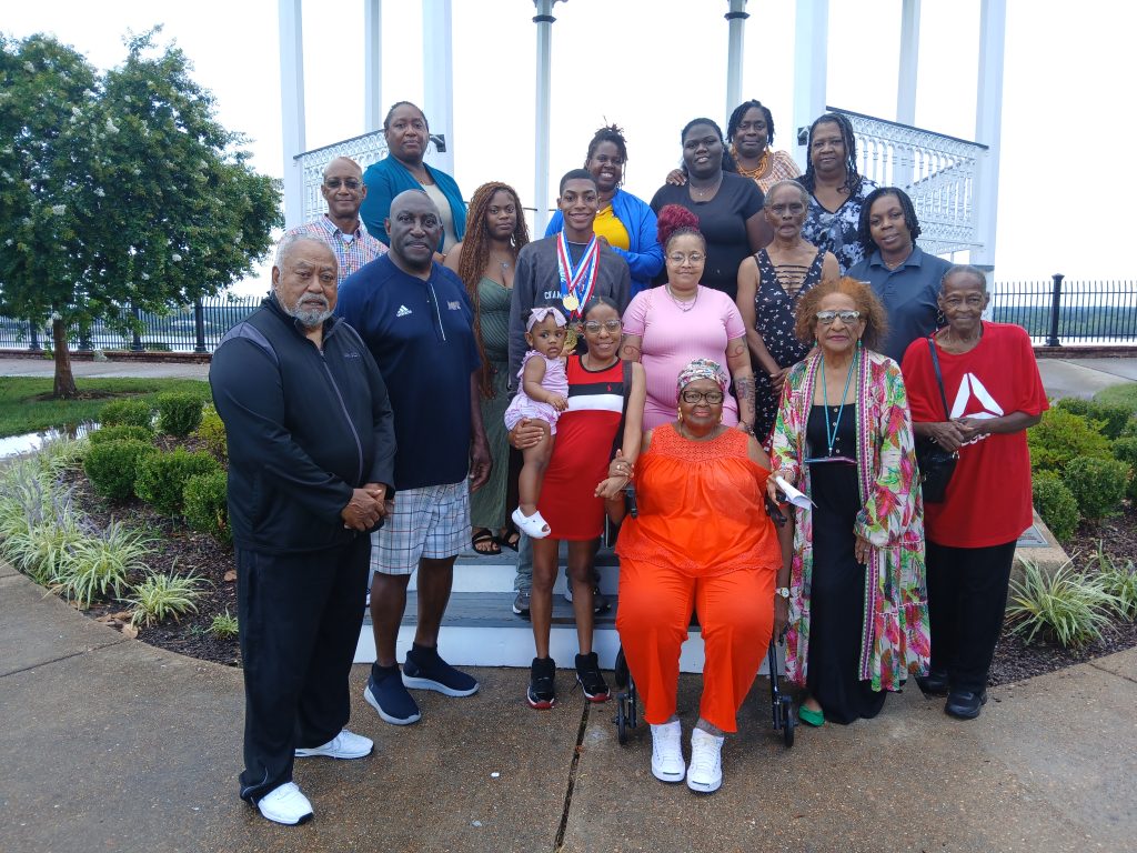 The family and friends of Markeith Thompson, center, recently visited the Bluff to show their support for him as the 2025 recipient of the $1,000 Hugh Green Scholarship. In addition to Hugh Green, the namesake of the scholarship, they were joined by Zandra McDonald, superintendent of the Natchez-Adams School District, and James Ricky Gray, District 4 supervisor for Adams County.