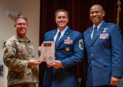 Chief Master Sgt. John Myers receives a token of appreciation during the state command chief Change of Responsibility at Joint Force Headquarters, Jackson, Mississippi, Aug. 1, 2025. Myers served in this position for three years and is set to take over as the Air National Guard Bureau's command first sergeant. (U.S. Air National Guard photo by Airman 1st Class Dawson Carter)