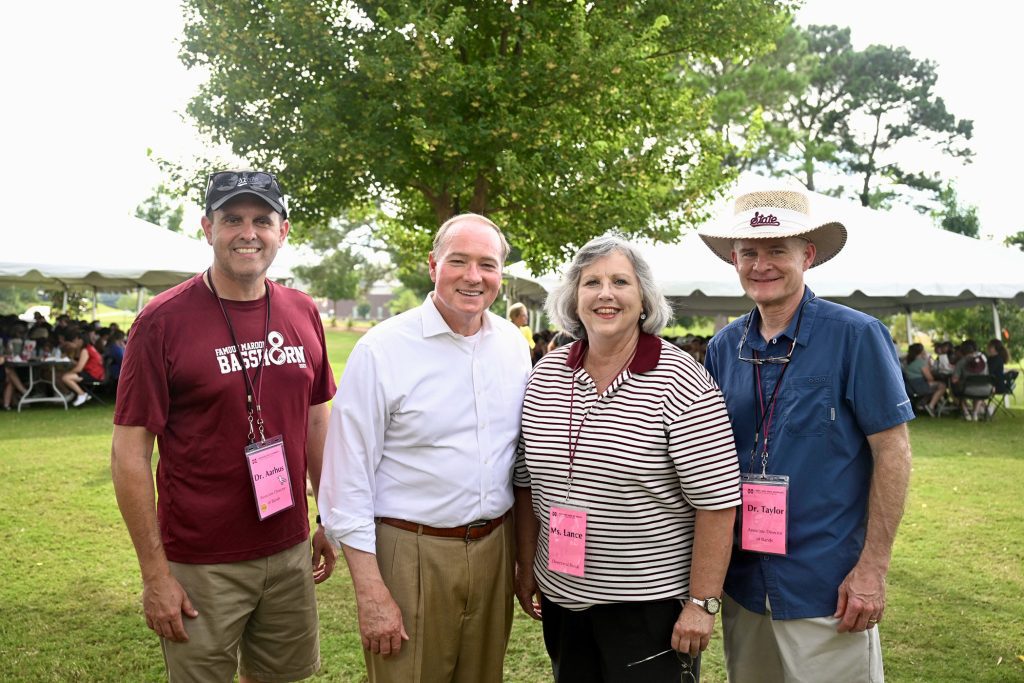 Pictured from left, Associate Director of Bands Craig Aarhus, MSU President Mark E. Keenum, Director of Bands Elva Kaye Lance and Associate Director of Bands Cliff Taylor during an Aug. 12 welcome-back dinner for the Famous Maroon Band at the Keenum home. (Photo by Emily Grace McCall)