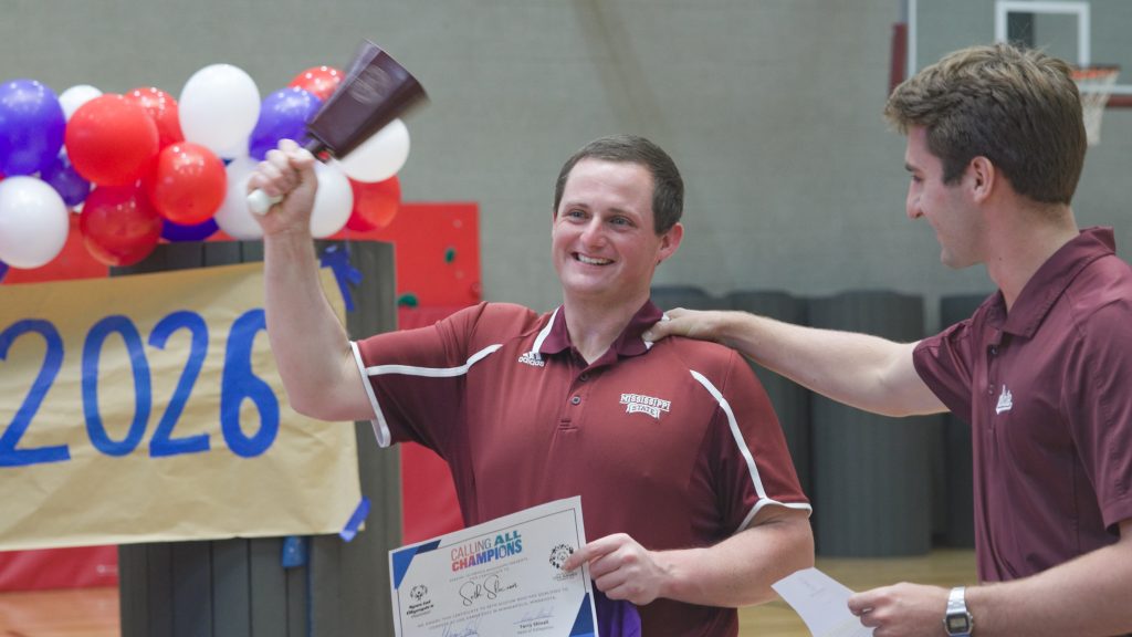 August Jones, right, congratulates Seth Slocum during a recent celebration. Jones is an MSU student from Bay Springs and Unified weightlifting coach who helps with Slocum’s training as a powerlifter. (Photo by Sarah Kirk)