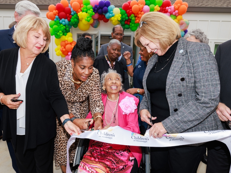 Clarke, center, smiles as former Mississippi First Lady Bryant, left, and Woodward, right, cut the ribbon on the Alyce G. Clarke Center for Medically Fragile Children.