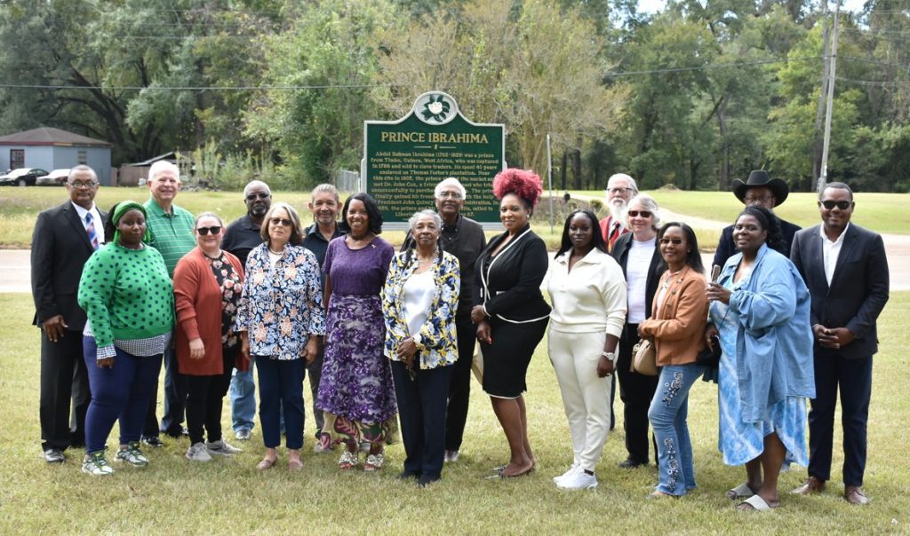 Descendants of Prince Ibrahima and Dr. John Coates Cox join members of the Natchez Historical Society for a photo in front of Ibrahima’s marker. Photo by Albert L. Jones