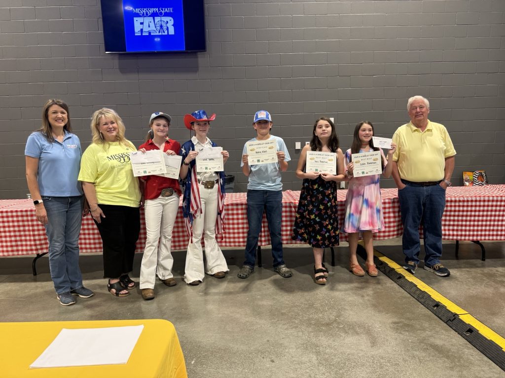 The Mississippi Egg Marketing Board, Mississippi Poultry Association, MSU Department of Poultry Science and Mississippi Beef Council announced the winners of the 2025 Great American Mississippi State Fair Omelet Cookoff. Pictured (L-R): Angela Evans, Host of WLBT's Studio 3; Dr. Ryn Laster, Mississippi Egg Marketing Board President; Best Patriotic Costume and 1st Place winners Evie and Charlie Haffey of Itawamba County; Henry Klein of Madison County, 3rd Place winner; Best Beef Omelet winners Kairi and Zelda Robertson of Madison County; and James Faison, Laboratory Manager for Mar-Jac Poultry Mississippi. Not pictured: Ellie Haffey of Itawamba County, 2nd Place winner.