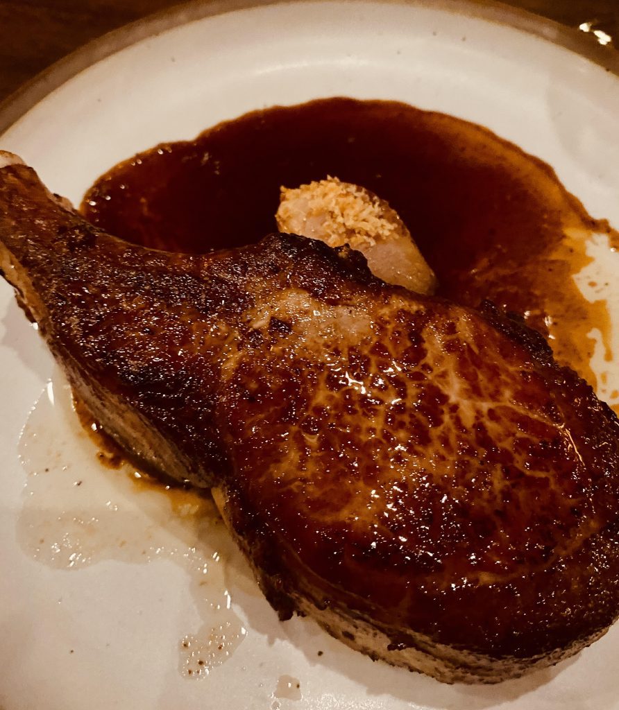 The Switchback at Cataloochee Ranch in Maggie Valley, NC, serves a pork chop that is hearty and delicious enough to be served alone. However, it pairs nicely with seasonal vegetables.