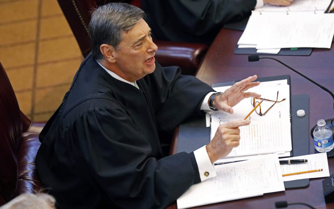 U.S. District Court Chief Judge Louis Guirola, Jr., of the Southern District of Mississippi, questions the student law school advocates during a moot court competition between the state's two law schools, Mississippi College School of Law and the University of Mississippi School of Law in Jackson, Miss., Wednesday, Sept. 27, 2017. (AP Photo/Rogelio V. Solis)