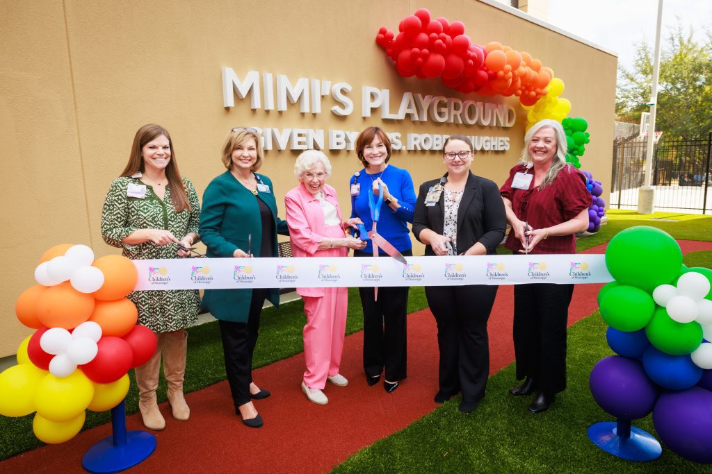 Cutting the ribbon on Mimi's Playground are, from left, Cara Williams, child life manager; Dr. LouAnn Woodward, vice chancellor for health affairs; philanthropist Robbie Hughes; Dr. Mary Taylor, Suzan B. Thames Chair of Pediatrics and incoming CEO of Children's of Mississippi; Dr. Nikki Cowan, director of nursing for Children's of Mississippi's medical-surgical and behavioral health units; and Tara Husband, director of Children’s Rehabilitative Services.