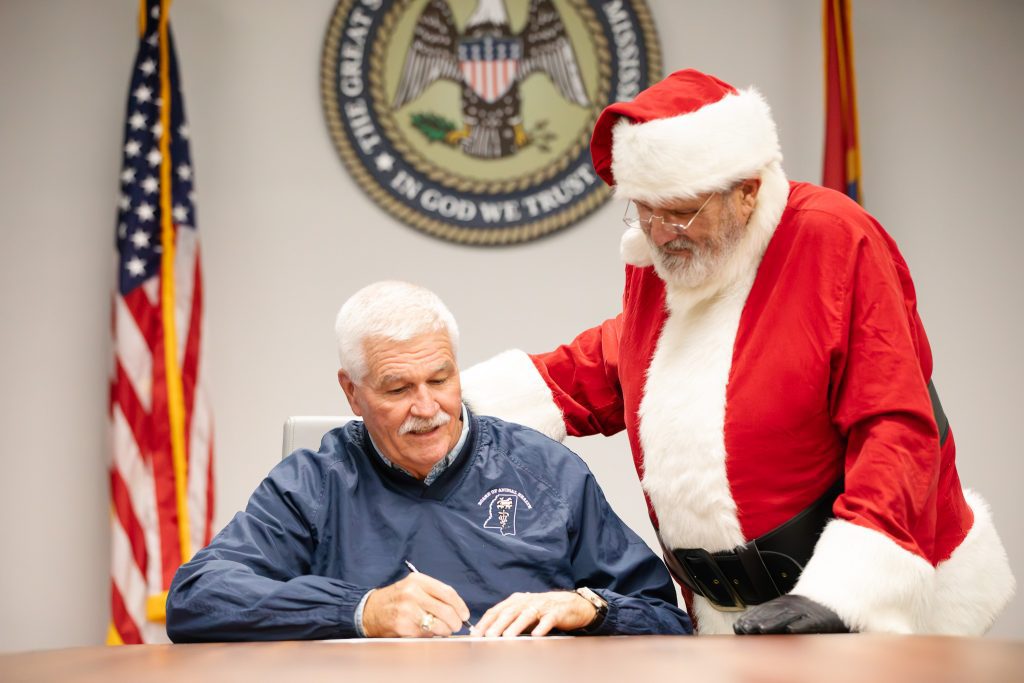 Dr. James Watson, State Veterinarian, issues a certificate of veterinary inspection to Santa Claus, permitting his reindeer to enter and exit the state of Mississippi on Christmas Eve, December 24.
