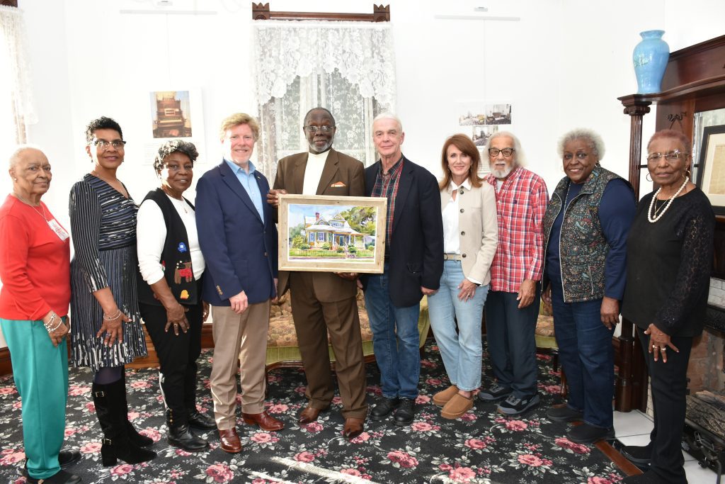 Wyatt Waters of Wyatt Waters Gallery recently donated a giclée print of his painting, “Dr. John Banks House,” to the staff of the Dr. John Bowman Banks Museum at 9. St. Catherine St. From left are Jacqulyn B. Williams, Velua Robinson, Thelma Newsome, Mayor Dan Gibson, Rev. LeRoy White, Wyatt Waters, Kristi Waters, Willie Woods, Dora Hawkins, and Bonita Reed. Photo by Albert L. Jones