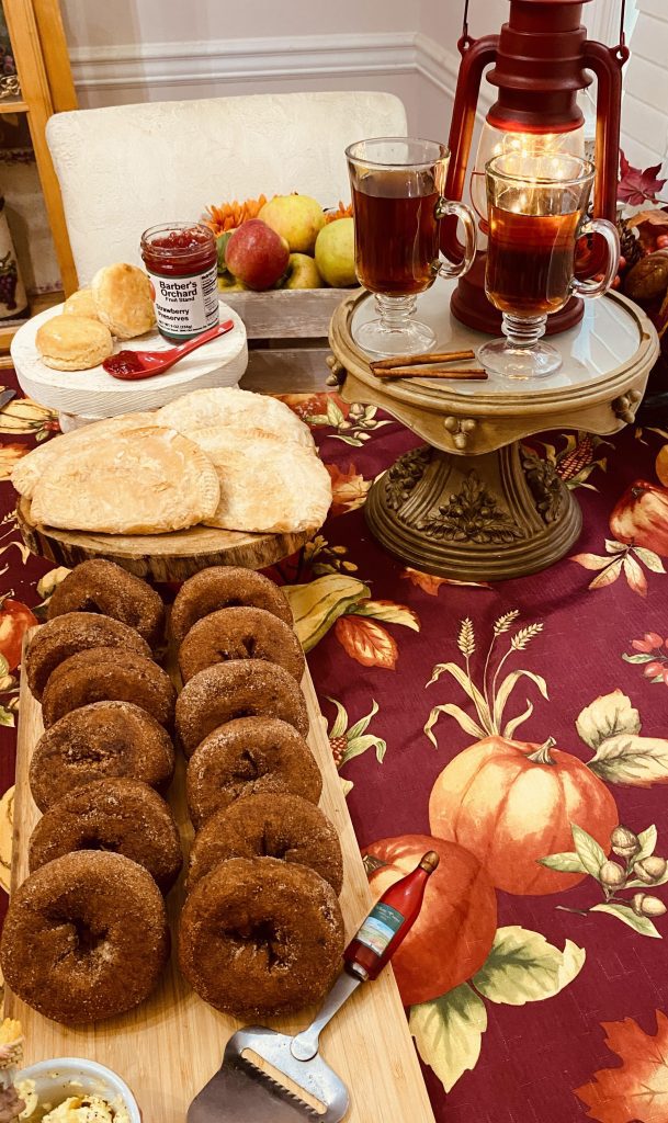 My carry-on suitcase was filled with delicacies from Barber Orchards and Bakery in Waynesville, NC. Back home, I created the perfect brunch that included, clockwise from bottom left: apple cider doughnuts, apple tarts, Barber’s strawberry preserves (and my homemade biscuits), apples I picked myself from a Waynesville apple orchard and hot apple cider. (Photo courtesy of Kara Kimbrough)