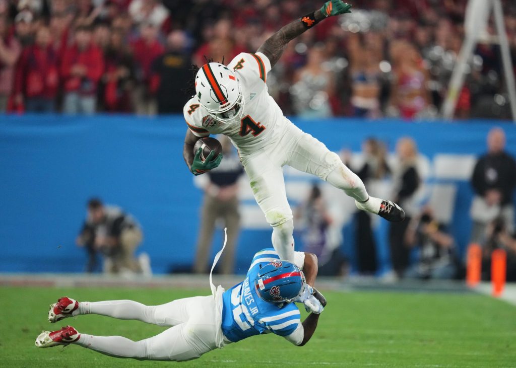 Mississippi cornerback Chris Graves Jr. (32) tackles Miami running back Mark Fletcher Jr. (4) during the first half of the Fiesta Bowl NCAA college football playoff semifinal game, Thursday, Jan. 8, 2026, in Glendale, Ariz. (AP Photo/Ross D. Franklin)