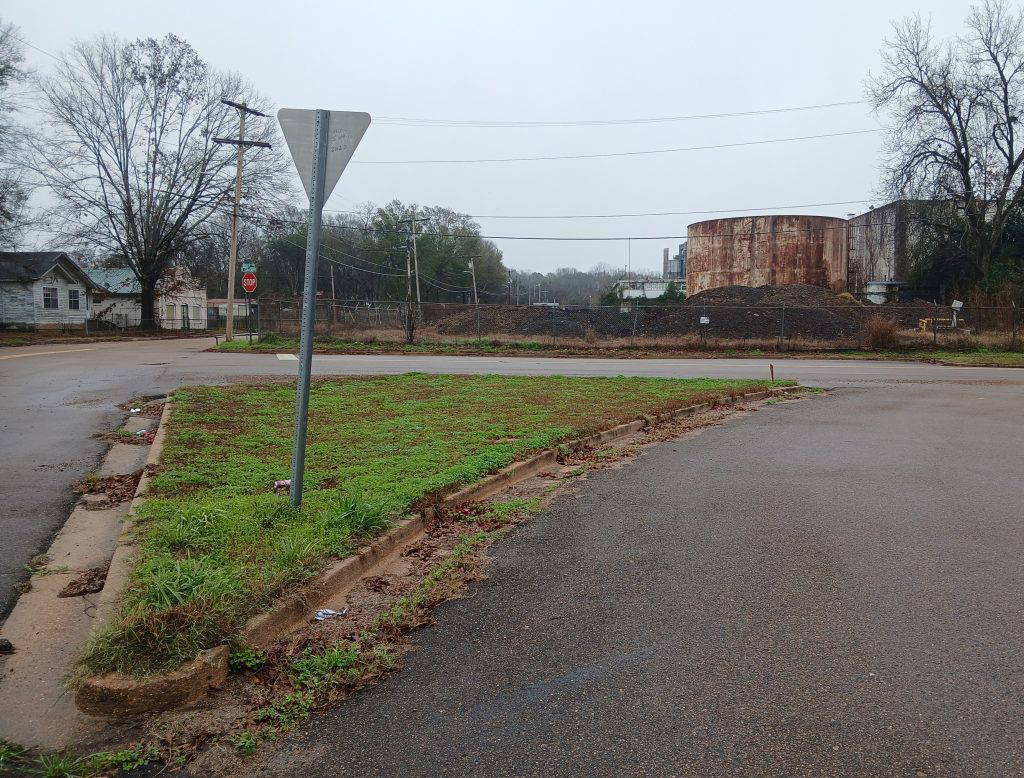 George Metcalfe’s car was parked in this area between Kelly Avenue, Brenham Avenue, and South Concord Avenue, when it was bombed by the Ku Klux Klan on August 27, 1965, near Armstrong Tire and Rubber Company. The plant can be seen here in the background. (Photo by Roscoe Barnes III)