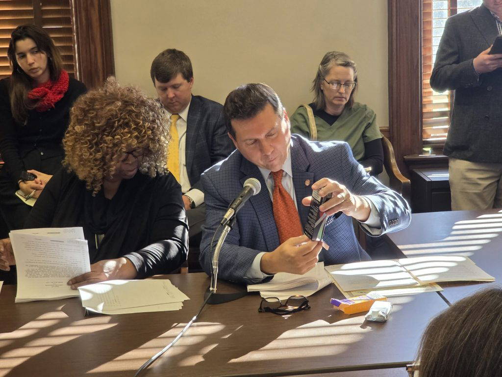 Rep. Lee Yancey (R) displays nicotine adjacent products being sold in the state during a recent House's Public Health and Human Services Committee meeting. (Photo by Jeremy Pittari)