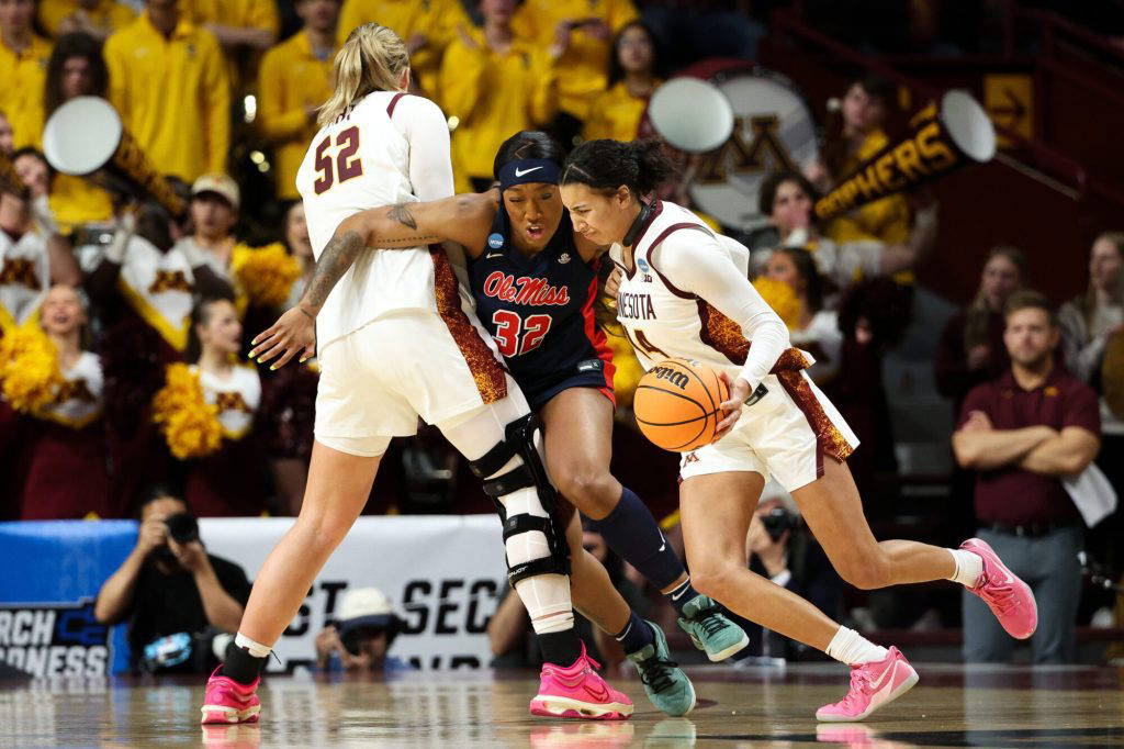Minnesota guard Tori McKinney, right, works around Mississippi forward Cotie McMahon (32) during the first half in the second round of the NCAA college basketball tournament, Sunday, March 22, 2026, in Minneapolis. (AP Photo/Matt Krohn)