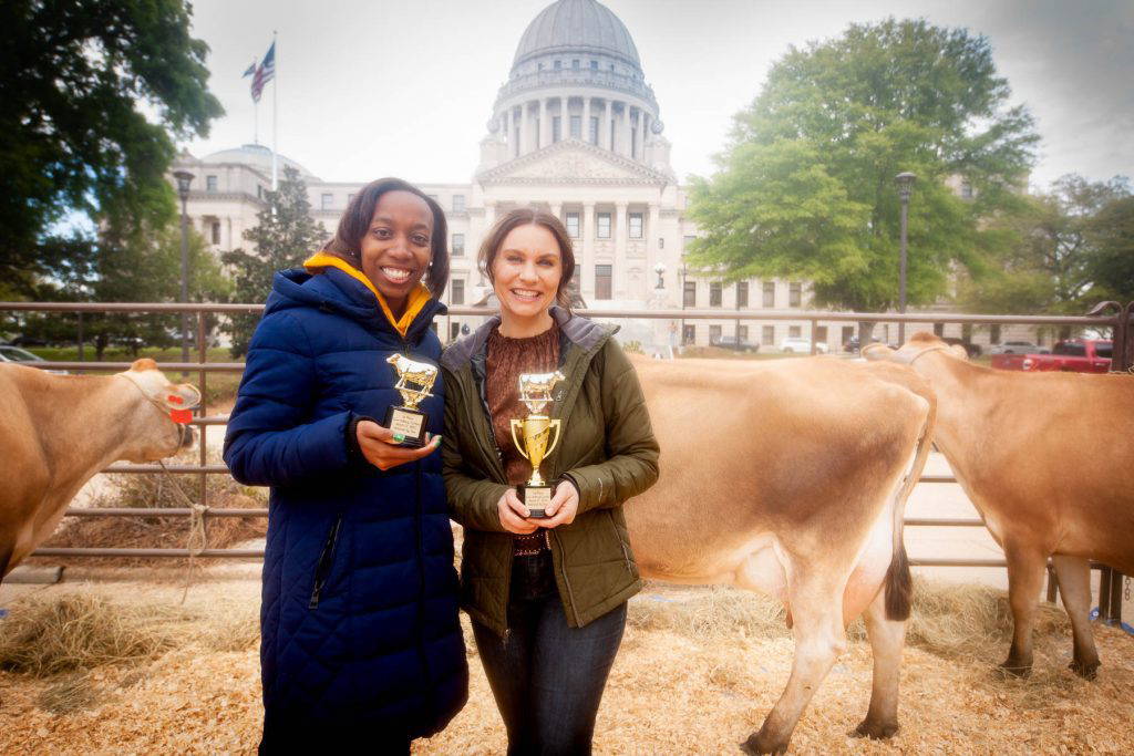 The Mississippi Department of Agriculture and Commerce held cow milking contests at the State Capitol during a press conference commemorating National Agriculture Day on March 21, 2023. The 2023 winners of the milking contests included First Lady of Agriculture Leslie Gipson and WJTV Anchor Kayla Thompson.