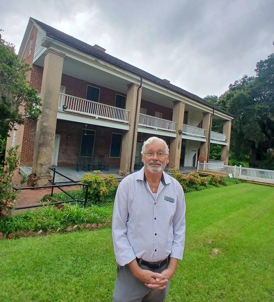 Douglas Lanfear, a docent at Longwood, stands in front of the historic quarters where enslaved families once lived. A first-floor room in the building will be used to interpret and present the history of those families.