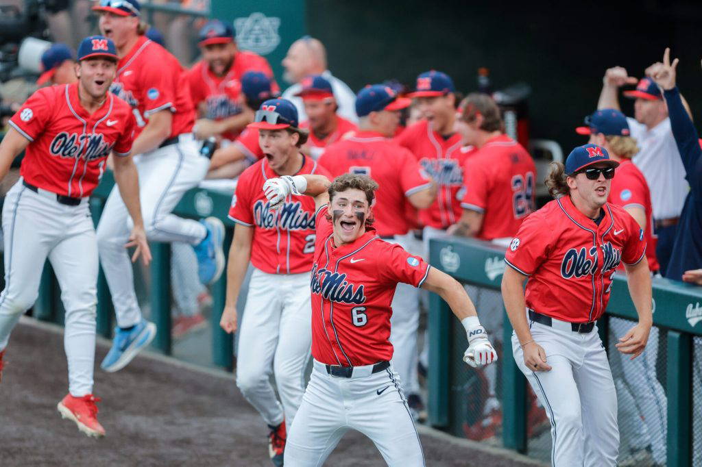 Ole Miss's Owen Paino (6) and teammates react to a 2-run home run by Will Furniss, not pictured during an NCAA super regional baseball game against Auburn on Saturday, June 6, 2026 in Auburn, Ala. (AP Photo/Stew Milne)